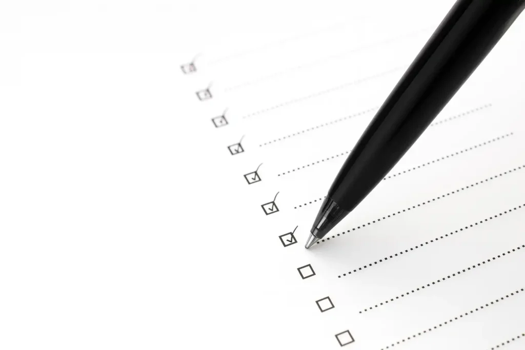 近距离拍摄的清单与黑色签字笔正逐项勾选,象征审计报告翻译前的核对流程,突出准确性、可核性与条目检查的严谨要求。